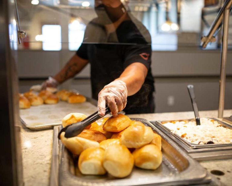 Golden Corral worker with rolls